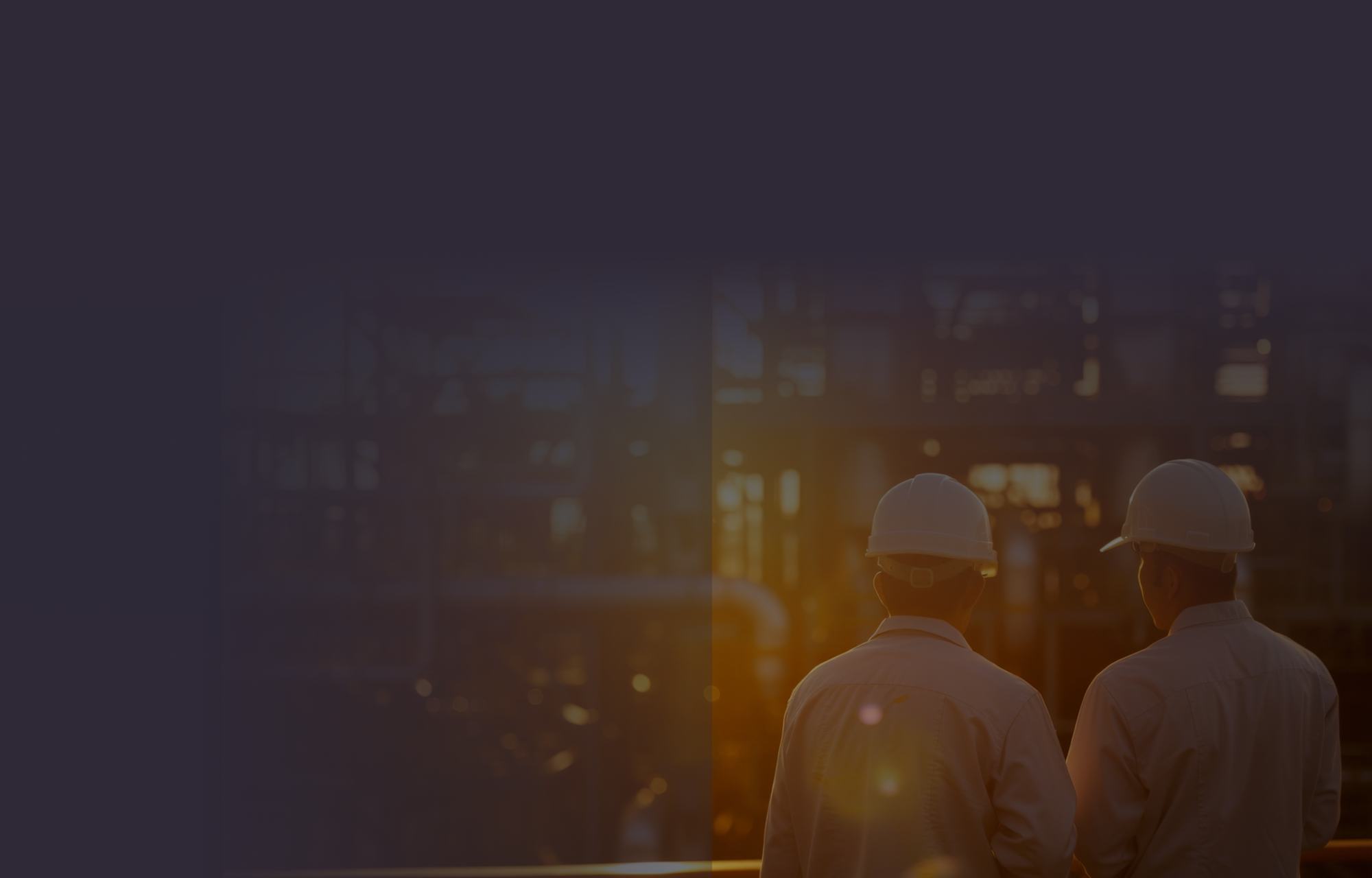 Two HOLT technicians in hard hats in a plant