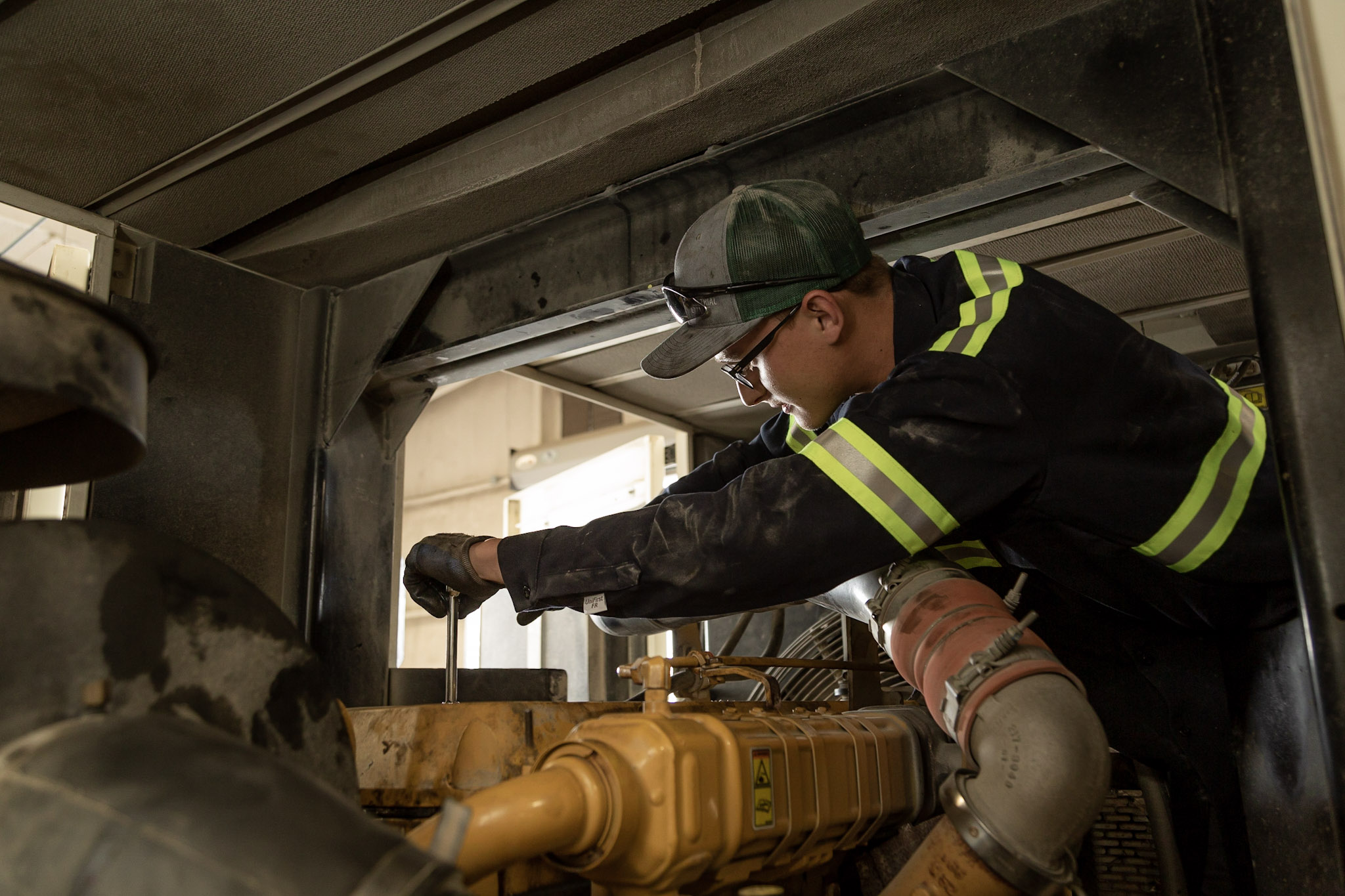 HOLT technician servicing an engine