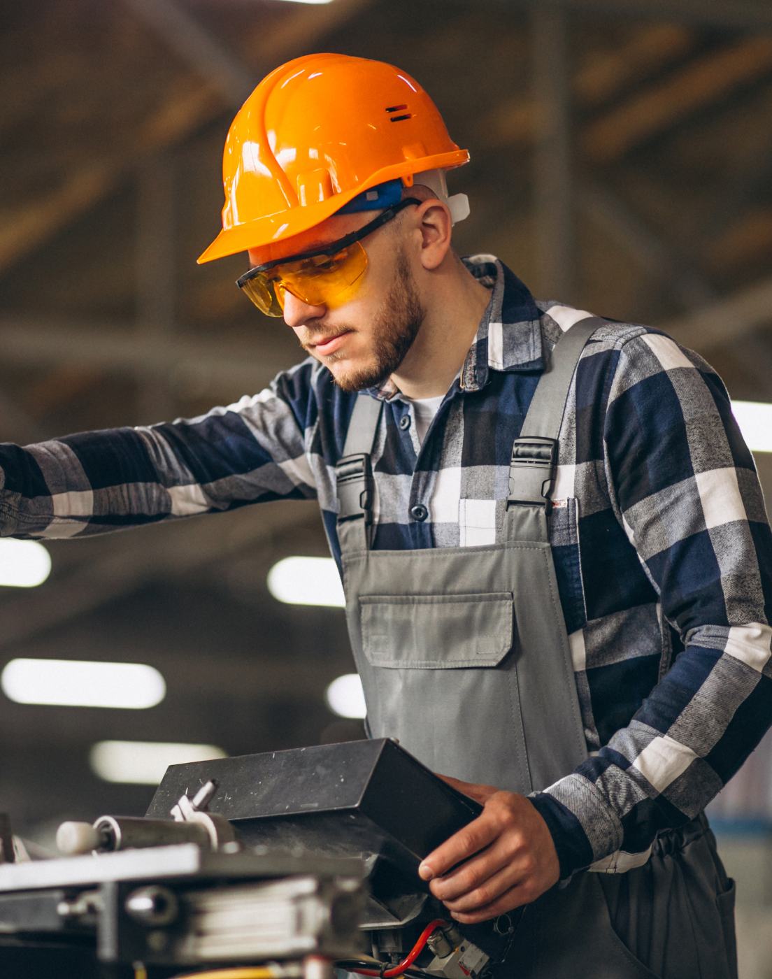 HOLT technician in safety gear inspecting equipment